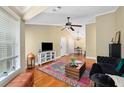 A bright living room featuring hardwood floors, ample natural light, and a cozy seating area at 188 Midland Parkway # 110, Summerville, SC 29485