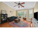 The inviting living room boasts a large window, hardwood floors, and comfortable seating arrangement at 188 Midland Parkway # 110, Summerville, SC 29485