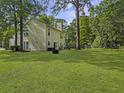 Expansive backyard featuring lush green grass, mature trees, and an open space for recreation at 206 Challis Ct, Goose Creek, SC 29445