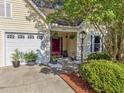 Inviting one-story home with a two-car garage, covered porch, and manicured landscaping at 206 Challis Ct, Goose Creek, SC 29445
