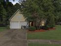 Inviting one-story home with a two-car garage, mature trees, and a well-manicured lawn at 206 Challis Ct, Goose Creek, SC 29445