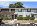 Charming exterior of townhomes with brick and gray siding, manicured shrubs, and convenient parking spaces at 21 Rivers Point Row # 3C, Charleston, SC 29412