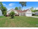 Charming one-story home with a well-manicured lawn, two-car garage, and mature landscaping at 217 Smithfield Ave, Summerville, SC 29485