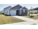 Charming single-Gathering home with a well-manicured lawn and a cozy front porch at 224 Coral Sunset Way, Summerville, SC 29486