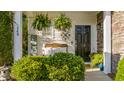 Inviting front porch with ferns, a sitting bench, and a decorative star, creating a cozy entrance at 240 Woodbrook Way, Moncks Corner, SC 29461