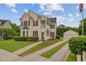 Charming two-story home with a detached garage, red shutters, and a manicured front yard at 249 Old Savannah Dr, Goose Creek, SC 29445