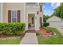 Inviting entryway of a lovely home, enhanced by beautiful landscaping and an ornate front porch at 249 Old Savannah Dr, Goose Creek, SC 29445