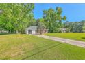 Quaint brick home with a spacious front yard and mature trees providing ample shade at 2736 Shadow Ln, North Charleston, SC 29406