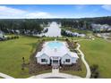 Stunning aerial view of community clubhouse and pool overlooking a serene lake at 291 Calm Water Way, Summerville, SC 29486