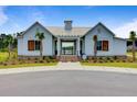 Beautiful white clubhouse with a metal roof, surrounded by well maintained landscaping at 291 Calm Water Way, Summerville, SC 29486