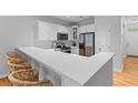 Bright kitchen with white cabinets, quartz countertops, and breakfast bar that is perfect for casual dining at 2948 Treadwell Street St, Mount Pleasant, SC 29466