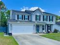 Charming two-story home with a spacious driveway, well-maintained lawn, and inviting curb appeal under a bright sky at 302 Axeminster Ct, Goose Creek, SC 29445