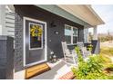 Inviting front porch with rocking chairs, stylish decor and a 'Welcome Home' doormat at 305 Flowering Peach Ct # 202, Charleston, SC 29414