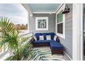 Cozy outdoor patio area with comfortable wicker seating and stylish tropical accents at 305 Flowering Peach Ct # 202, Charleston, SC 29414
