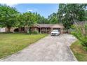 Charming brick home with lush lawn, blooming flowerbeds and a single car garage at 313 Houston Dr, Ladson, SC 29456
