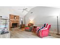 Cozy living room features a brick fireplace, vaulted ceiling and stylish wood-look floors at 313 Houston Dr, Ladson, SC 29456