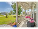 Relaxing front porch featuring a porch swing with pink pillows and comfortable outdoor seating at 3173 Hugh Bennett Dr, Johns Island, SC 29455