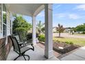 Inviting front porch with seating, perfect for enjoying neighborhood views and summer evenings at 318 Oyster Bay Dr, Summerville, SC 29486