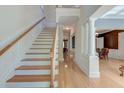 Bright foyer featuring hardwood floors, elegant staircase, and classic architectural details at 321 Bounty Ln, Charleston, SC 29412