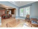 Spacious living room with hardwood floors, blue accent wall, and large windows for natural light at 321 Bounty Ln, Charleston, SC 29412