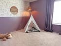 Whimsical ' bedroom with a decorative wallpaper, teepee, and a cozy carpeted floor at 323 Bear Paw Ln, Summerville, SC 29486