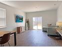 Bright living room with wood flooring, a comfortable sofa, and a sliding door to the backyard at 323 Bear Paw Ln, Summerville, SC 29486