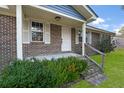 Close-up of a brick home entrance with tidy landscaping and classic features at 33 Elliott Ct, Walterboro, SC 29488