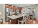 Modern kitchen with granite countertops, stainless steel appliances, and eat-in island at 3901 Poplar Grove Pl, Summerville, SC 29483