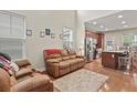 Open-concept living room and kitchen featuring stainless steel appliances and a cozy seating area at 3901 Poplar Grove Pl, Summerville, SC 29483