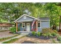 Cozy single-story home with a quaint front porch, manicured landscaping, and a welcoming American flag, reflecting pride at 4546 Holly St, North Charleston, SC 29405