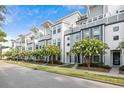 Street view of stylish townhomes featuring contemporary designs, well-maintained lawns, and beautiful curb appeal at 4557 Mixson Ave, North Charleston, SC 29405