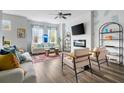 Bright living room with fireplace, featuring hardwood floors, ceiling fan, and stylish furniture at 4557 Mixson Ave, North Charleston, SC 29405