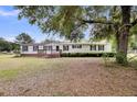 Inviting single-story home with classic design and a lush green yard at 5056 Red Oak Rd, Cottageville, SC 29435