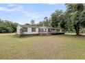 Attractive single-story home with a well-maintained lawn and inviting front entrance at 5056 Red Oak Rd, Cottageville, SC 29435