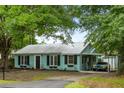 Charming home featuring a metal roof, updated windows, and a welcoming covered parking area at 532 Sunset Dr, Charleston, SC 29407