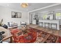 Inviting living room featuring an open layout, modern decor, wood floors, and a seamless transition to the kitchen at 5774 Scott White Rd, Hollywood, SC 29449