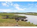The waterway sits next to a grassy yard with a broken deck and a grill for cookouts by the water at 6240 Old Point Rd # C-8, Hanahan, SC 29410