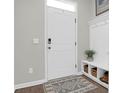 Welcoming mud room adjacent to front door with storage, a plant, and patterned rug at 725 Pepperbush St, Charleston, SC 29414