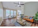 Bright and spacious living room with hardwood floors, ample natural light, and comfortable seating arrangements at 7690 High Maple Cir, North Charleston, SC 29418