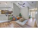 Cozy living room with vaulted ceilings, hardwood floors, and stylish decor, perfect for relaxation and entertaining at 7690 High Maple Cir, North Charleston, SC 29418