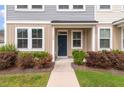 Inviting entrance of townhome with neat landscaping, blue door, and ample windows at 7780 Montview Rd, North Charleston, SC 29418