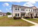 Two-story townhome features neutral siding, well-maintained lawn, and pathway leading to the entrance at 7780 Montview Rd, North Charleston, SC 29418