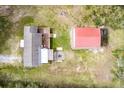 An overhead shot showcasing a home's deck, fire pit and outbuilding, all nestled in a serene outdoor setting at 8476 Old Georgetown Rd, McClellanville, SC 29458