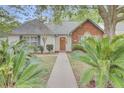 Lovely home with lush landscaping, a brick-accented facade, and a welcoming pathway to the front door at 8774 Adaline St, North Charleston, SC 29406