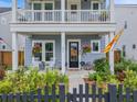 Close-up of front porch featuring hanging plants and a decorative wreath at 886 Clay Field Trl, Summerville, SC 29485