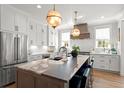 Beautiful kitchen with a large island, stainless appliances, and stylish lighting at 9822 Haven Loop, Johns Island, SC 29455