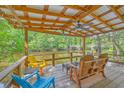 Inviting covered deck with river view and outdoor seating, perfect for relaxing and enjoying the serene surroundings at 100 Canal Rd, Saint George, SC 29477