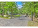 Grand gated entrance to a secluded property with a long driveway and manicured grounds, ensuring privacy and exclusivity at 100 Canal Rd, Saint George, SC 29477