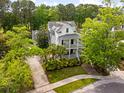 Beautiful two-story home with double porches, mature trees, and lush landscaping at 11 Dalton St, Daniel Island, SC 29492