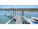 View along the dock with a boat, clear water, and boat lift at 1141 Hills Plantation Dr, Charleston, SC 29412